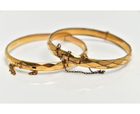 TWO YELLOW METAL BANGLES, the first a hinged bangle with a faceted design, stamped 'gold metal core', together with a second 