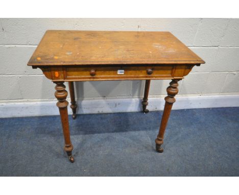 AN EARLY 20TH CENTURY OAK SIDE TABLE, with a single frieze drawer, on turned and tapered legs, with ceramic casters, width 87