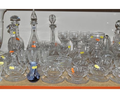 A GROUP OF CUT CRYSTAL, comprising a ship's decanter, a contemporary style decanter (chipped stopper), three other decanters,