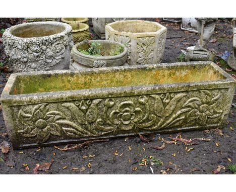 A WEATHERED COMPOSITE RECTANGULAR PLANTER, with a floral design, length 98cm x depth 25cm x height 25cm