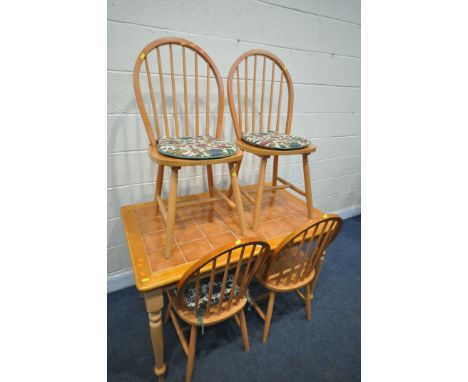 A BEECH TILE TOP KITCHEN TABLE, length 120cm x depth 75cm x height 75cm, and four hoop back chairs (condition:-partially over