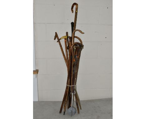 A BUNDLE OF WALKING STICKS SHOOTING STICK, WALKING CANES, ETC, a few with metal mounts and inscriptions, s.d (13)