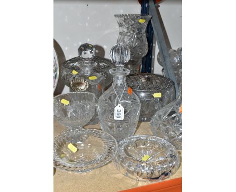 A GROUP OF CUT GLASS, comprising three decanters, two rose bowls, a table lamp, bon-bon dish, ashtray and jug (9) (Condition 