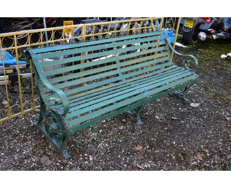 A GREEN PAINTED STRAPWORK IRON BENCH, with scrolled arms and supports, length 184cm (condition:-weather and overpainted)
