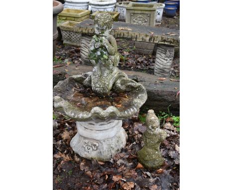 A WEATHERED COMPOSITE SHELL SHAPED BIRD BATH, with a mythical creature playing an instrument, height 74cm, and a small gnome 