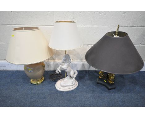 A CHELSOM LIGHTING MODEL CN/7784/BA EBONISED AND GILT TABLE LAMP, with a black shade, along with a figural table lamp of a ho