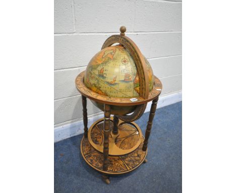 A MID TO LATE 20TH CENTURY DRINKS GLOBE, with a lid that's enclosing a fitted interior, on four turned uprights, and casters,