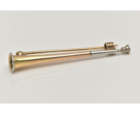 A YELLOW METAL HUNTING BROOCH, in the form of a horn with white metal mount, stamped 9ct, fitted with a brooch pin and textur
