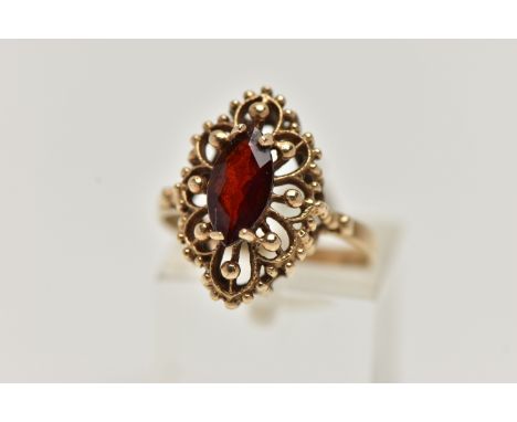 A 9CT GOLD GARNET RING, of an openwork marquise outline, set to the centre with a marquise cut garnet in a four claw setting,