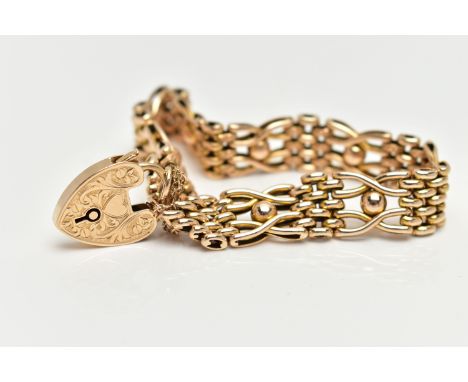 A 15CT YELLOW GOLD, WIDE GATE BRACELET, featuring textured oval links and ball detail, fitted with a heart padlock clasp with