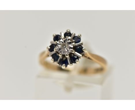 A 9CT GOLD SAPPHIRE AND DIAMOND CLUSTER RING, centring on a single cut diamond illusion set, in a surround of circular cut bl