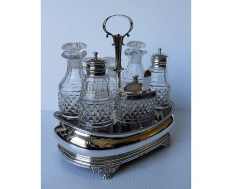 A George III silver and crystal navette-shape cruet set with seven matching bottles, the salt, pepper and mustard with confor