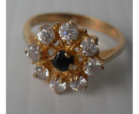 An 18ct yellow gold sapphire and diamond ring is a cage setting, 3.65g, size N (testing for 18ct gold).