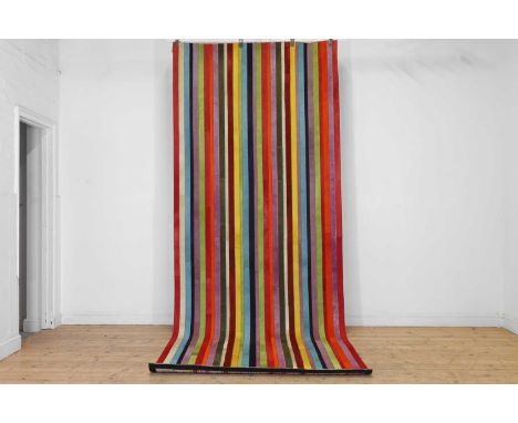 A polychrome cowhide carpet or runner, of recent manufacture, with stitched strips of coloured hide,394 x 149.5cm