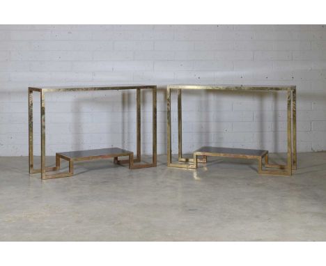 A pair of brass console tables, attributed to Guy Lefevre, c.1970, each with a black-lacquered top and an undertier shelf, 12