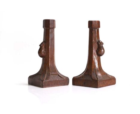 ▲ Robert 'Mouseman' Thompson (1876-1955), a pair of carved oak octagonal candlesticks, c.1930, each with lappet details, on a