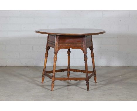 A rosewood and ivory-inlaid circular centre table,  late 19th century, in the manner of E W Godwin, by Collinson & Lock, the 
