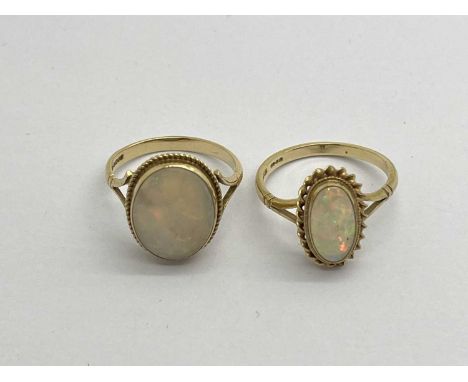 Two 9ct Gold Vintage Opal Set Rings, the oval stones to rubover setting, within twisted border, between bifurcated shoulders 