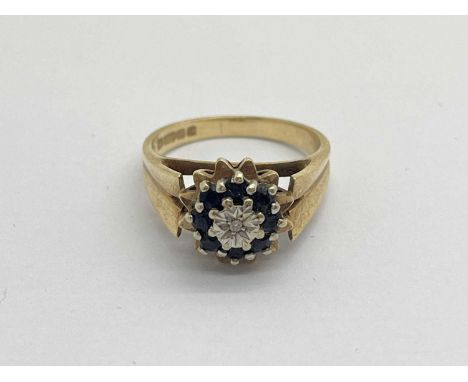 A 9ct Gold Vintage Brutalist Style Ring, the illusion set diamond to centre, between sapphire halo and starburst design setti