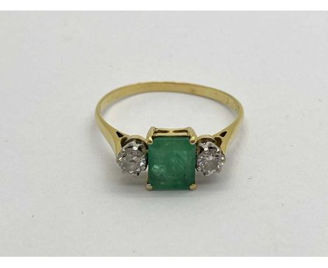 An Emerald and Diamond Three Stone Ring, rectangular four claw set to the centre, between two brilliant cut diamonds (hallmar