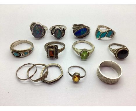 A Hallmarked Silver Band Ring, of uniform starburst texture, together with a collection of "925" rings, to include Navajo mos