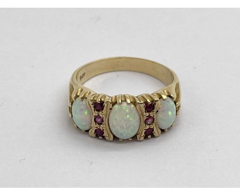 A Victorian Style Three Stone Ring, the oval stones alternately set, between reeded claw setting, stamped "9ct", (finger size