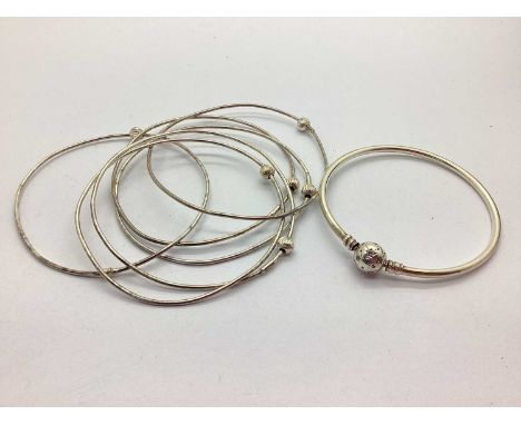 Modern Bangles, stamped "925", with textured bead detail"; a Pandora Moments Stars and Galaxy Bangle, the inset ball clasp st