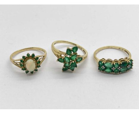 A 9ct Gold Opal and Emerald Set Cluster Ring, between dainty bifurcated shoulders, (finger size R), together with another 9ct