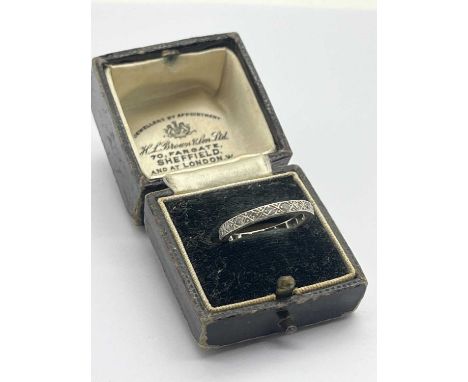 A Dainty Diamond Set Eternity Band, set with single cut stones, inscribed "Plat H.L.B." (finger size N), in a vintage H.L. Br