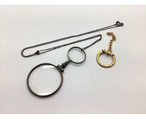 A 9ct Gold Key Ring Clasp, together with a vintage magnifying glass, on a fine chain.