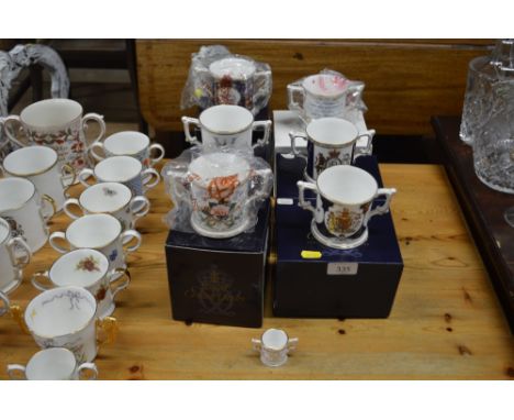 Six Royal Crown Derby loving cups with original boxes; and a miniature Royal Crown Derby loving cup 