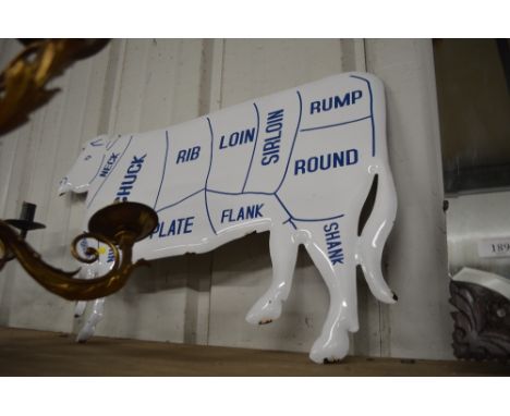 An enamel cow sign 