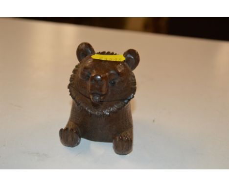 A Black Forest carved wooden inkwell in the form of a bear