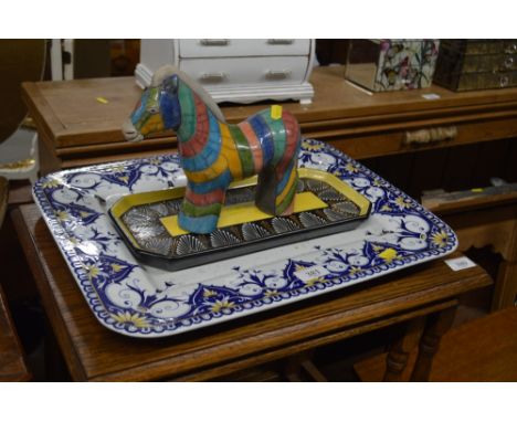 A pottery multi coloured glazed horse ornament; together with a Quimper pottery tray; and a French pottery meat plate 