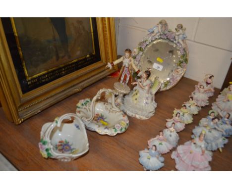 A continental porcelain floral encrusted easel mirror; together with a Dresden figure group; and two floral decorated baskets