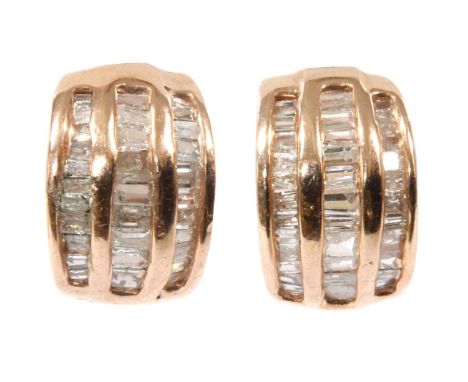 A pair of silver rose gilt diamond earrings, three rows of baguette and tapered baguette cut diamonds, channel set to a half 