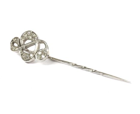 An 18ct white gold diamond set treble clef stick pin, by Theo Fennell, the finial in the form of a treble clef, grain set wit