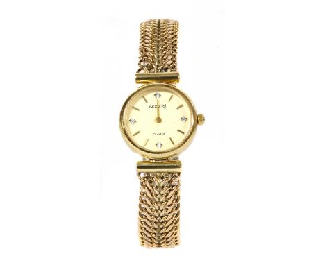 A ladies' 9ct gold Accurist quartz bracelet watch, 21mm diameter with cream dial, gilt baton hour markers and eight cut diamo