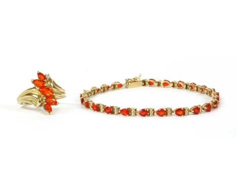 A 9ct gold fire opal bracelet, a row of pear mixed cut fire opals, approximately 4 x 3mm, claw set to articulated collets wit