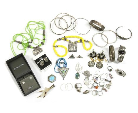 A quantity of silver jewellery, to include an interlocking three row bangle, a hollow hinged oval bangle with hand engraved d