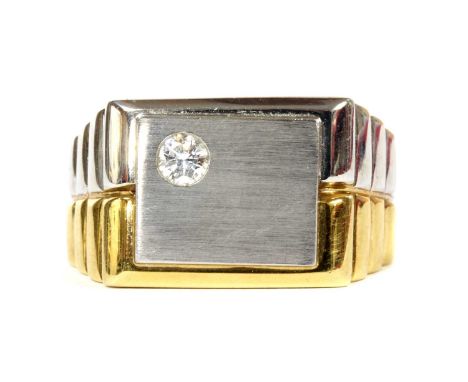 A gentlemen's 18ct two colour gold diamond set ring, a brilliant cut diamond, with a stated weight of 0.14ct, gypsy set to th