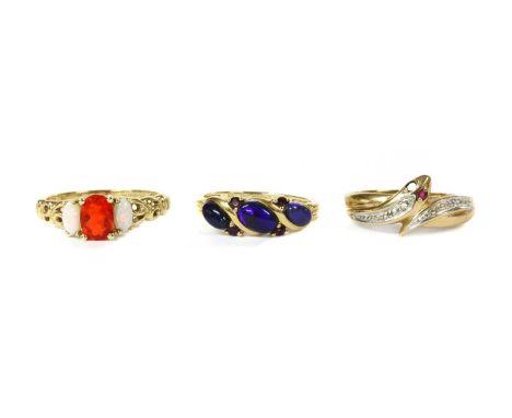 Three 9ct gold rings, to include a three stone fire opal and white opal ring, Birmingham 2000, a three stone opal ring, Birmi