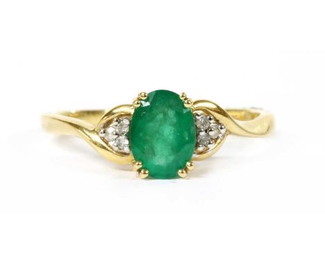 A 9ct gold emerald and diamond ring, an oval mixed cut emerald, approximately 7 x 5mm, claw set with a trefoil of brilliant c