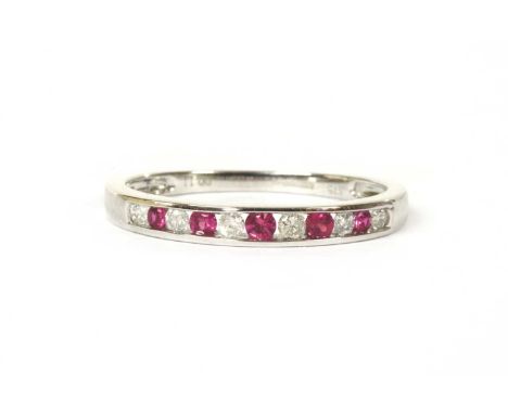 A 9ct white gold ruby and diamond half eternity ring, an alternating row of circular mixed cut rubies and brilliant cut diamo