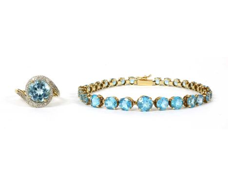A 9ct gold blue topaz bracelet, a row of graduated circular mixed cut blue topaz, claw set to articulated collets, to box cla