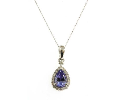 A white gold tanzanite and diamond halo cluster pendant, a pear cut tanzanite with surround of eight cut diamonds, all claw s