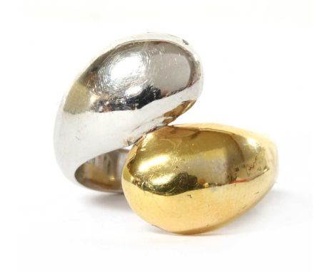 A two colour gold ring, the lobed crossover head in half white gold and half yellow gold, to plain yellow gold shank, tested 