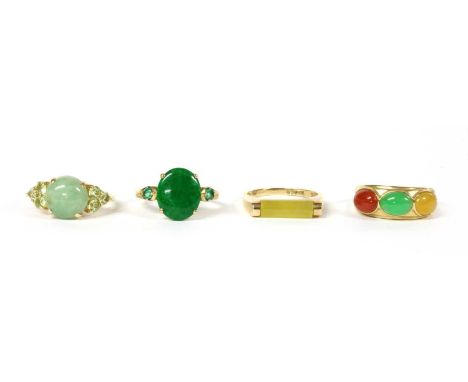 A 14ct gold three stone jade ring, Birmingham 2000, together with a 9ct gold jade ring, Birmingham, a 9ct gold jade and emera