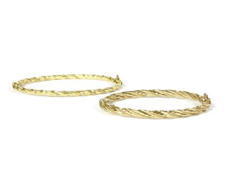 A 14ct gold oval hollow twisted wire bangle, with sprung hinge and figure of eight catch, Birmingham 2002, internal dimension