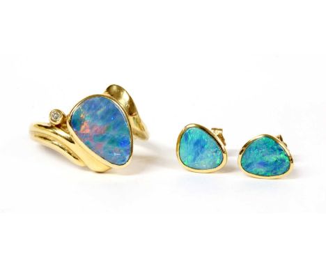 A 14ct gold opal and diamond ring, a boulder opal, or opal doublet, approximately 13 x 9mm, rub set, with a brilliant cut dia